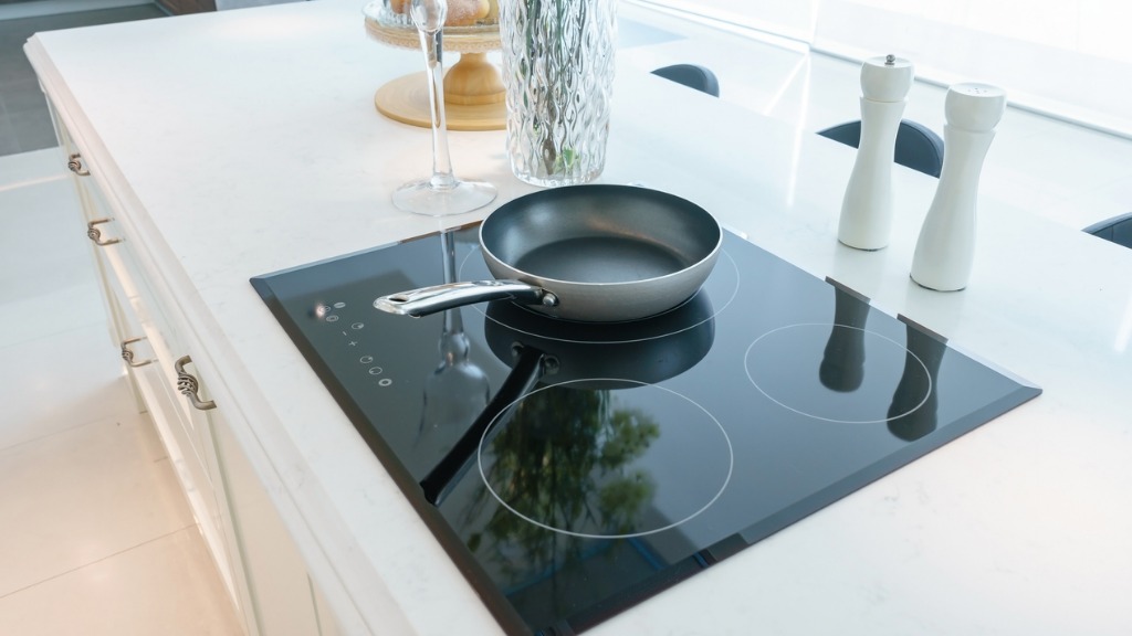 Frying pan on modern black induction stove cooker hob or built in picture id916807096